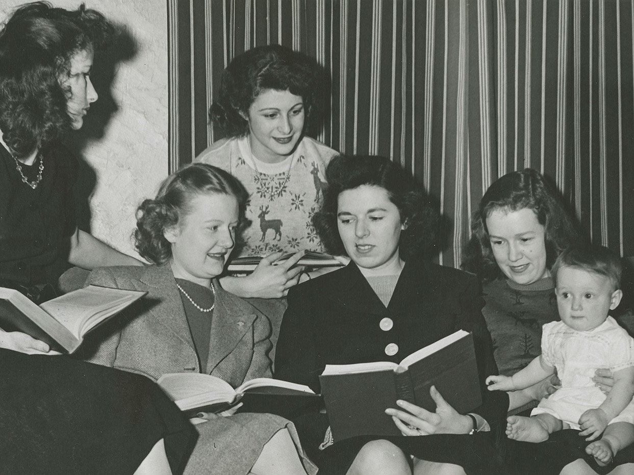 Five female students studying with infant