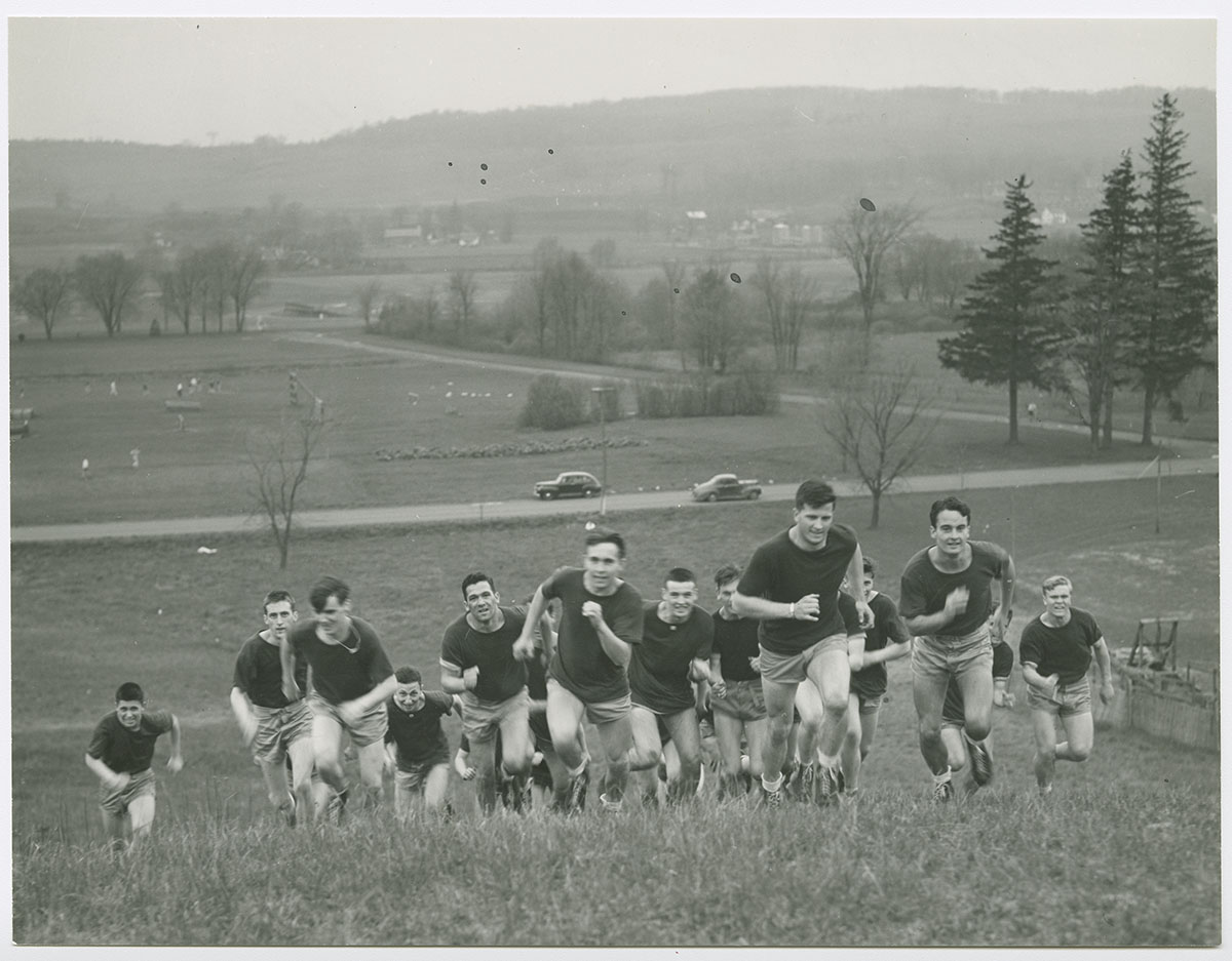 Bill Geyer, Class of 1942, leads cadets up the ski slope, dubbed "Agony Hill," 1943