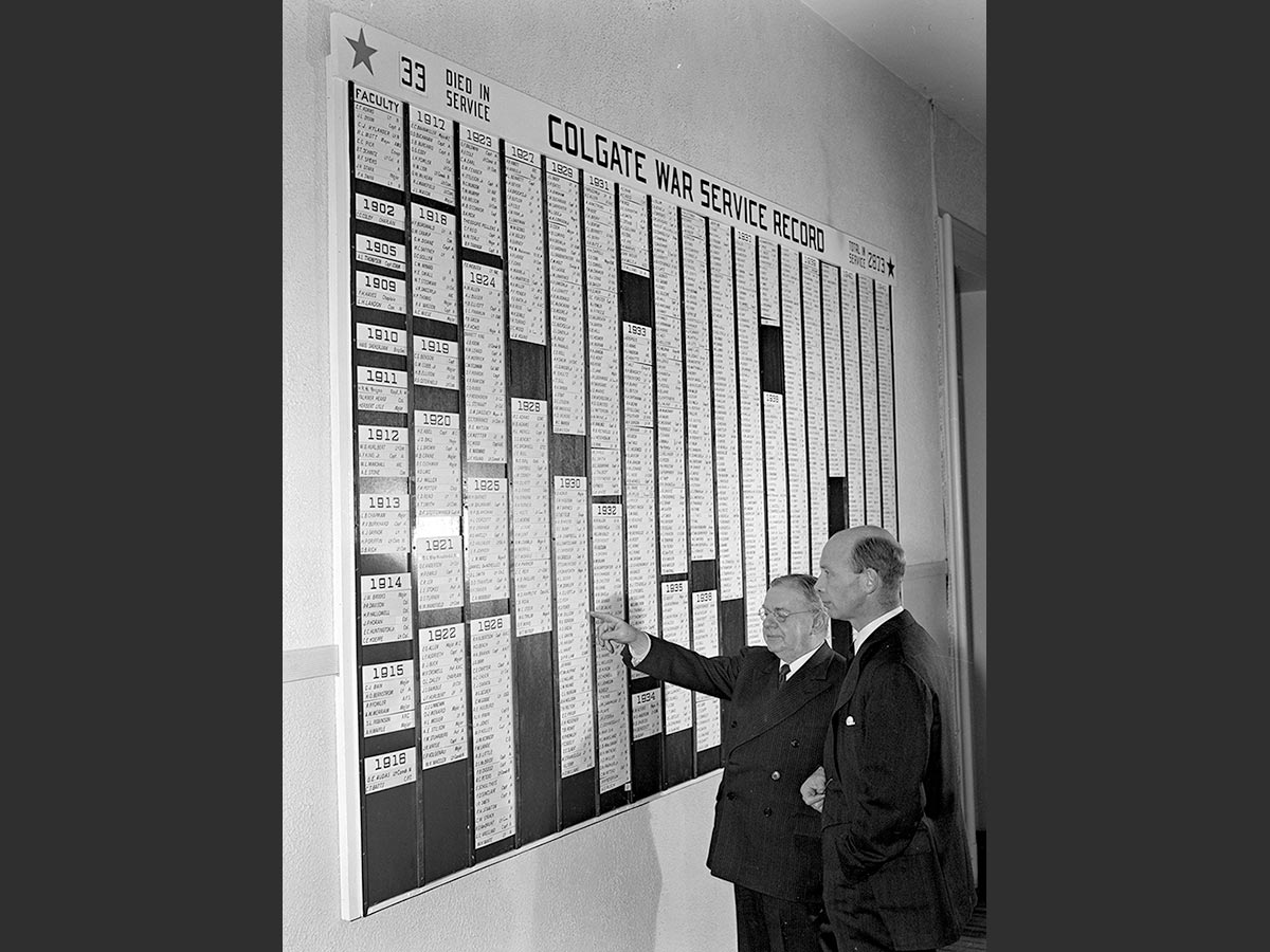 President Everett Needham Case and Harold Whitnall view Colgate War Service Record, 1944