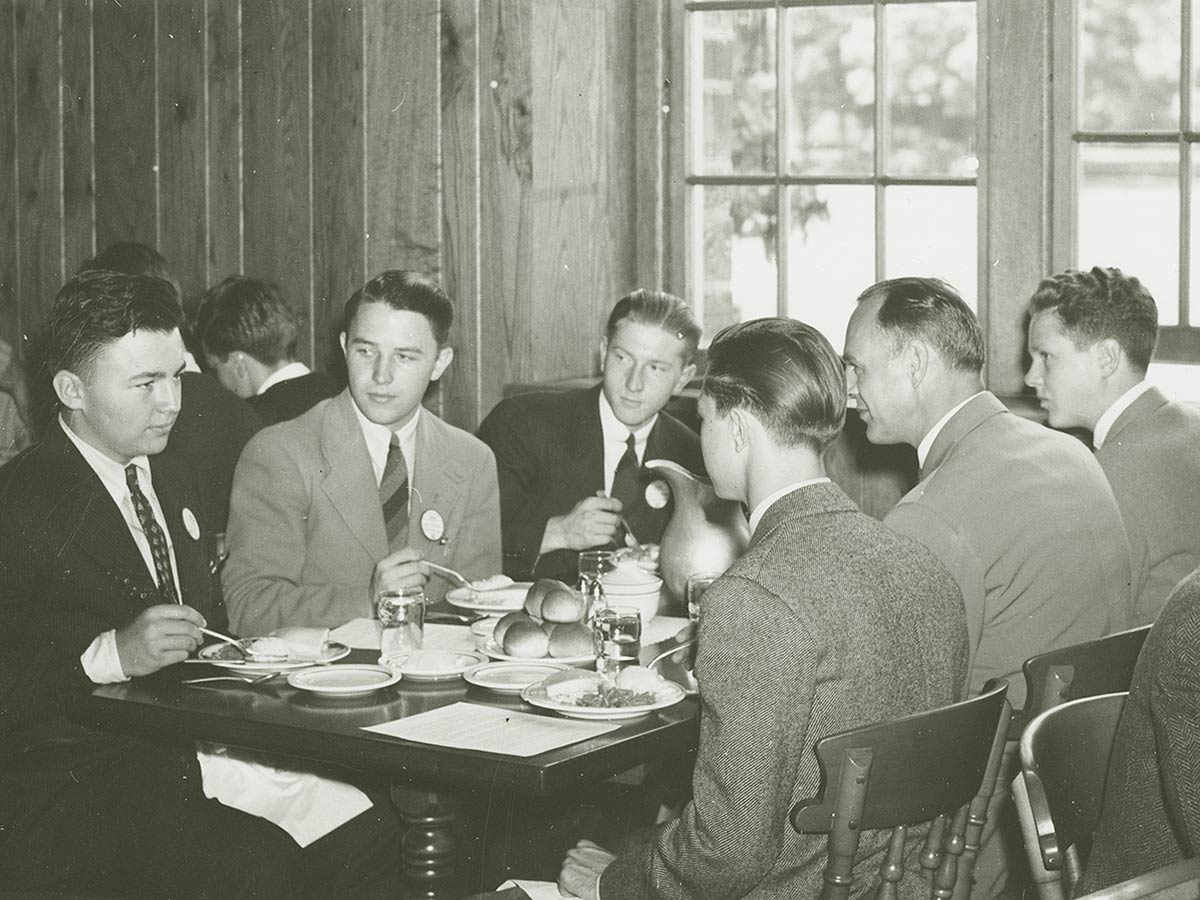 Students in jackets and ties eating dinner