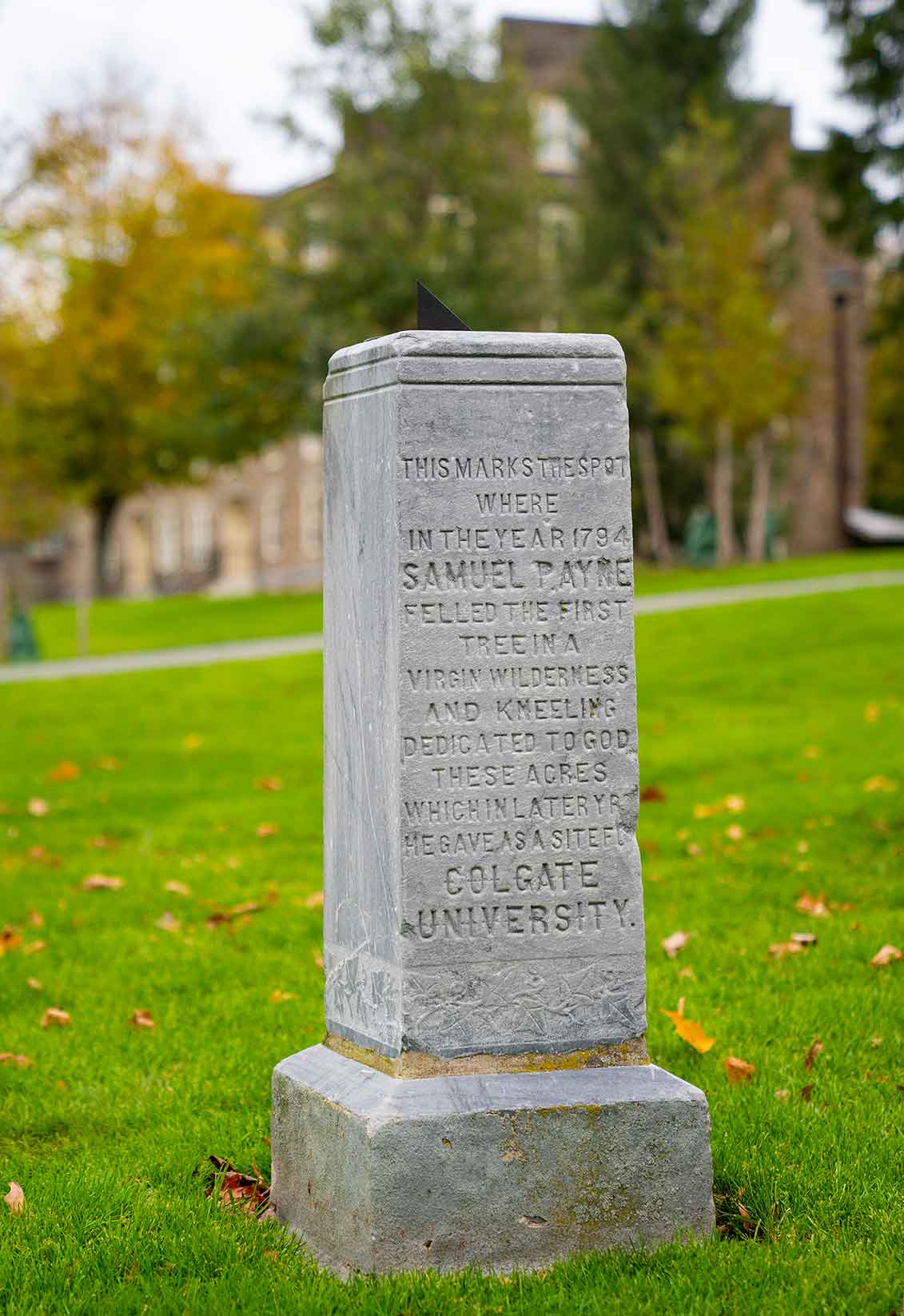Stone Monument that reads This marks the spot where in the year 1794 Samuel Payne Felled the first tree in a virgin wilderness and kneeling dedicated to God these acres which in later years he gave as a site for Colgate University