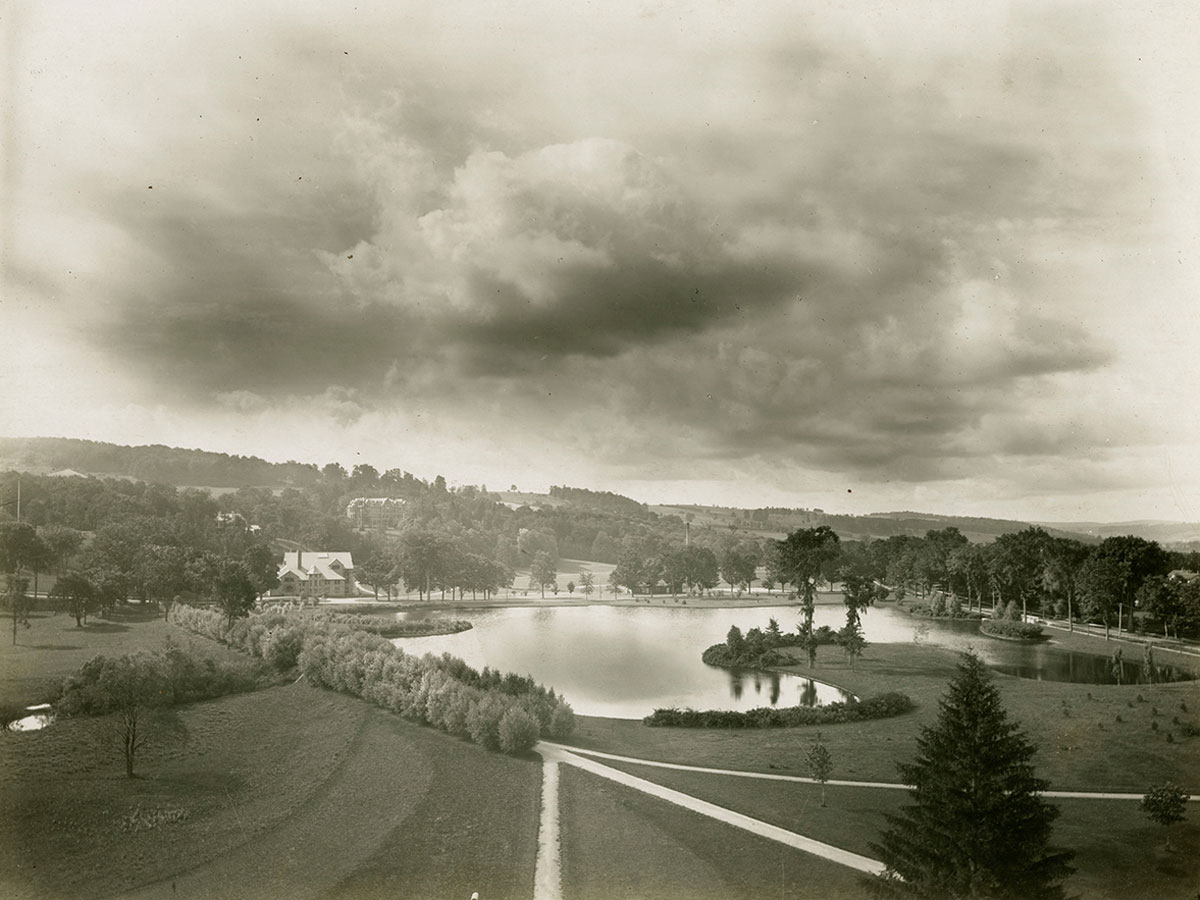 Black and white archival image of Willow Path and Taylor lake, with Eaton Hall visible in the distance.