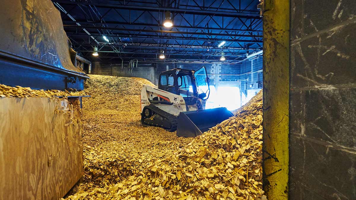 Tractor on pile of wood chips 