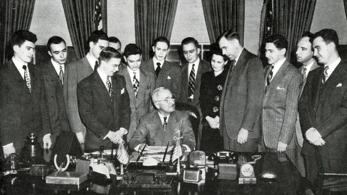 Group of students with Pres Harry Truman in oval office